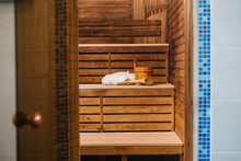 Bucket Of Water And Bathrobe On A Bench In The Sauna