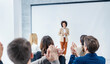 © Dusan Petkovic - An african businesswoman having speech at symposium while audience applauding her.