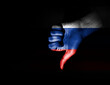 hand making dislike sign painted in the colors of the russian flag