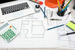 © RomanR - house project plan with work tools and helmet on desk