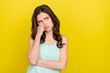 Photo of unhappy upset negative mood lady look blank space thinking about her problems isolated on yellow color background