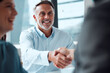 © Micah C/peopleimages.com - Recognising and commending the efforts of his team. Shot of a mature businessman shaking hands with a colleague during a meeting in an office.