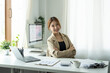 © Natee Meepian - Portrait of young beautiful asian businesswoman looking at camera and smile, arms crossed in modern office workplace