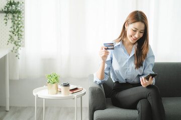 Portraits of beautiful smiling Asian women relax using laptop computer technology while sitting on their desks and using their creativity to work, work from home concept.