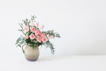 Bouquet Of Peony Roses In Ceramic Jug On White Background
