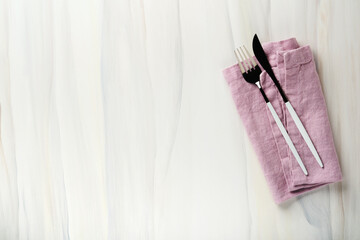 Wall Mural - Ceramic empty white plate and pink linen kitchen towel napkin on old ceramic tile table background. Cooking stone backdrop. Top view with copy space. Flat lay