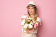 © Danko - Photo portrait of caucasian girl smiling happy received bunch flowers isolated on pastel pink color background