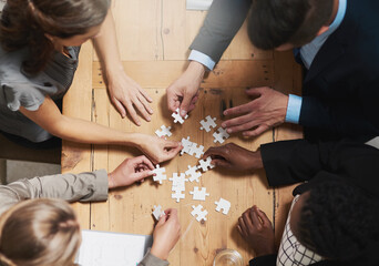 Aufkleber - Putting their vision together. High angle shot of a group of businesspeople building a puzzle together in an office.