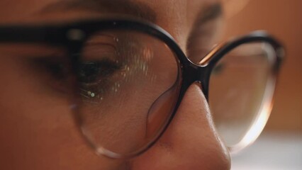The programmer works at the computer over the program in a dark room. Close up woman eyes using internet, reading, watching, styding, analyzes