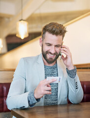 Poster - Just thought Id give you a call back. Cropped shot of a modern businessman using his cellphone in a coffee shop.