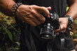 © Cavan Images - Man using bacelletes holding his profesional camera