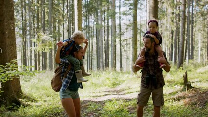 Wall Mural - family with small children walking outdoors in summer nature.