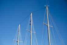 Closeup Of The Masts Of A Sailboat On Blue Sky Background In Rotterdam, The Netherlands