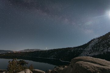 Canvas Print - Beautiful view of a landscape with a lake and a forest under the starry sky