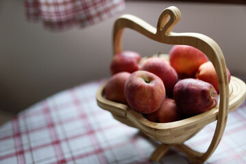 Closeup of fresh red apples in a fruit basket on a table