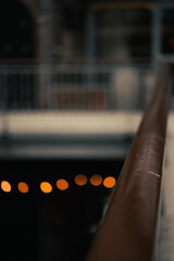 Canvas Print - Vertical shallow focus closeup shot of the railing of the balcony of an arcade