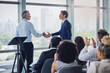 © Adene Sanchez/peopleimages.com - The floor is yours. Cropped shot of two businessmen shaking hands during a seminar in the conference room.