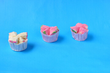 Wall Mural - Steamed sponge cake, or bolu kukus food from Indonesia. isolated on a blue background