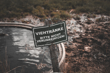 Closeup shot of the german sign for not contaminating cattle troughs