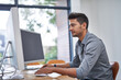 © Ruan Jordaan/peopleimages.com - Focused and ready to meet the deadlines. Shot of a confident young man working on his computer in the office during the day.