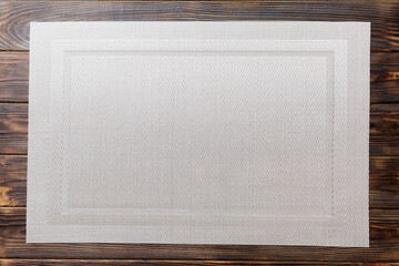 Wall Mural - Top view of grey tablecloth for food on wooden background. Empty space for your design