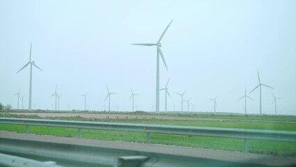 Wall Mural - Large wind turbines with blades in field blue sky wind park. Alternative energy