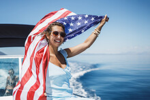 Woman With US National Flag Spending Day On Private Yacht