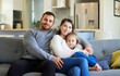 © Nina L/peopleimages.com - No better feeling than being with them. Shot of a young family relaxing on the couch at home.