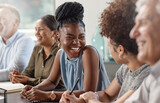 Laughter can brighten up your day. Shot of a group of businesspeople in a meeting at work.