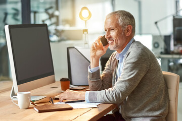 Poster - You have my full attention. Shot of a mature businessman talking on the phone while sitting at his desk in an office.