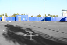 Empty Parking Lot On Blue Fencing Background