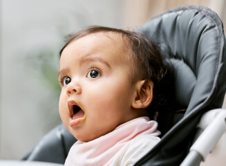 Poster - Can I have some more, please. Shot of an adorable baby girl sitting in her feeding chair.