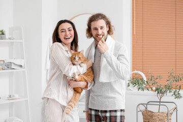 Poster - Happy couple with cat brushing teeth in bathroom