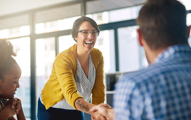 Fototapete - Were so glad that youll be joining our team. Cropped shot of businesspeople shaking hands in an office.