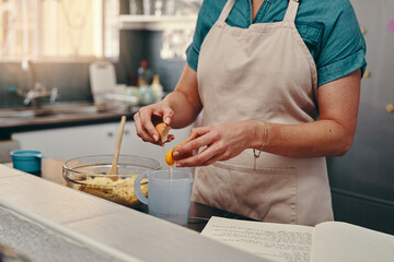 Canvas Print - Lets get it cracking. Cropped shot of an unrecognizable woman cracking egg shells while baking inside her kitchen.