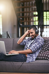 Aufkleber - Thats my jam. Shot of a young man using a laptop and headphones on the sofa at home.