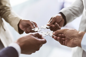 Poster - Do you see the bigger picture. Closeup shot of a group of unrecognizable businesspeople joining puzzle pieces together in an office.