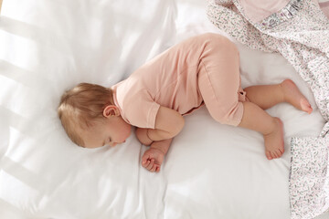 cute little baby sleeping on soft bed, top view