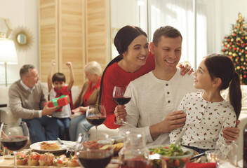 Wall Mural - Happy family enjoying festive dinner at home. Christmas celebration