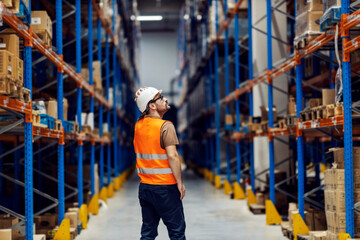 Wall Mural - A warehouse supervisor looking for package for delivery.