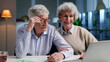 © TommyStockProject - Portrait of happy elderly couple shopping online on laptop together