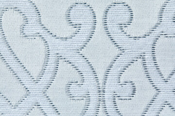 Beautiful texture of fabric Wallpaper embossed in form of a classic floral ornament in light gray and white tones.