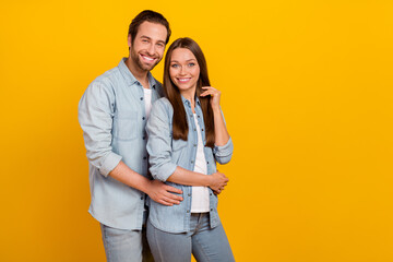 Poster - Portrait of attractive cheerful couple married spouses hugging copy blank space isolated over bright yellow color background