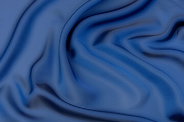 Wall Mural - Close-up texture of natural blue fabric or cloth in same color. Fabric texture of natural cotton, silk or wool, or linen textile material. Blue canvas background.