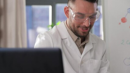 Sticker - distance education, school and science concept - happy smiling male chemistry teacher in earphones with laptop computer having online class and showing molecular model on flip chart at home office