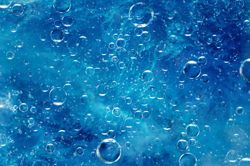 large air bubbles under water, blue background