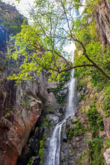 Wall Mural - Waterfall among the rocks on a mountainside in the Serra do Cipo region of the Brazilian Cerrado (savanna) biome in Minas Gerais