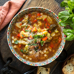 Wall Mural - bowl with traditional italian minestrone soup on the table