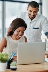 Canvas Print - Giving her a helping hand. Cropped shot of a young man helping a female colleague with something at her desk.