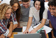 © Jeff Bergen/peopleimages.com - Having a laugh between classes. Shot of a group of young college students working together on a laptop.